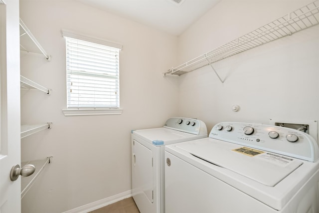 clothes washing area featuring independent washer and dryer