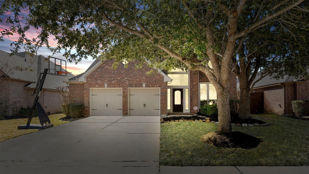 view of front facade with a yard and a garage