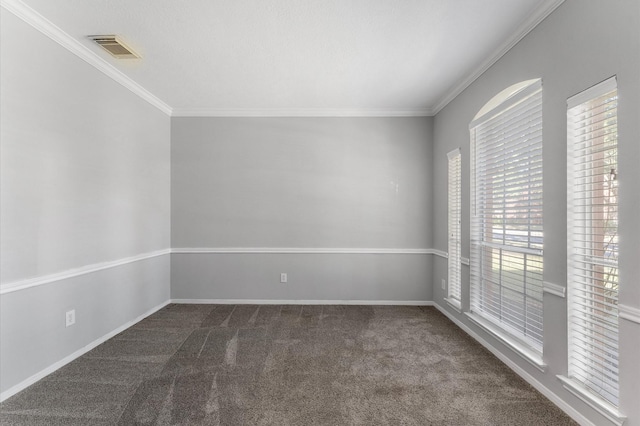 carpeted spare room featuring ornamental molding