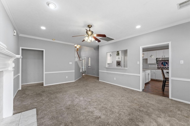 unfurnished living room with ornamental molding, carpet, and ceiling fan