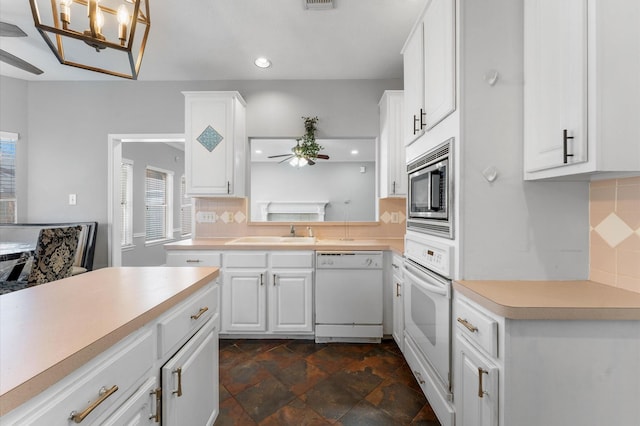 kitchen with sink, white appliances, ceiling fan, white cabinetry, and tasteful backsplash