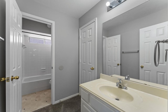 bathroom with vanity, tiled shower / bath combo, and a textured ceiling