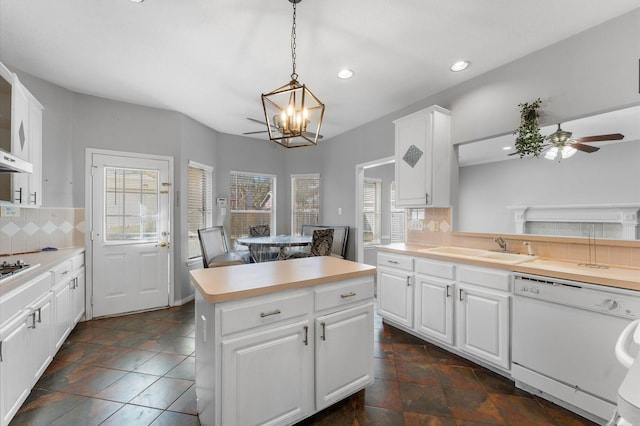 kitchen with white cabinetry, sink, hanging light fixtures, and dishwasher