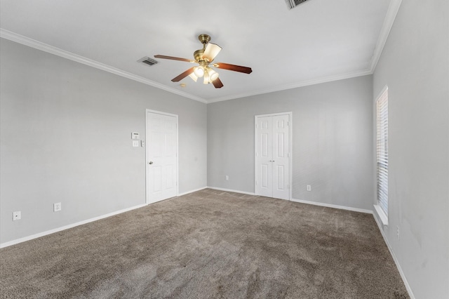 spare room featuring ornamental molding, ceiling fan, and carpet