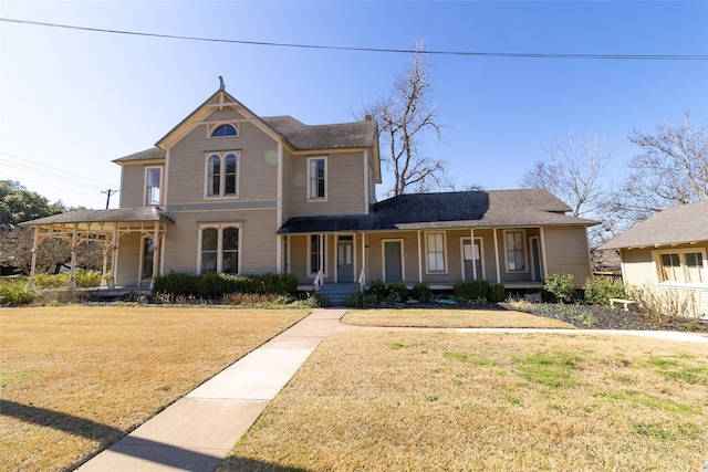 view of front of home featuring covered porch and a front yard