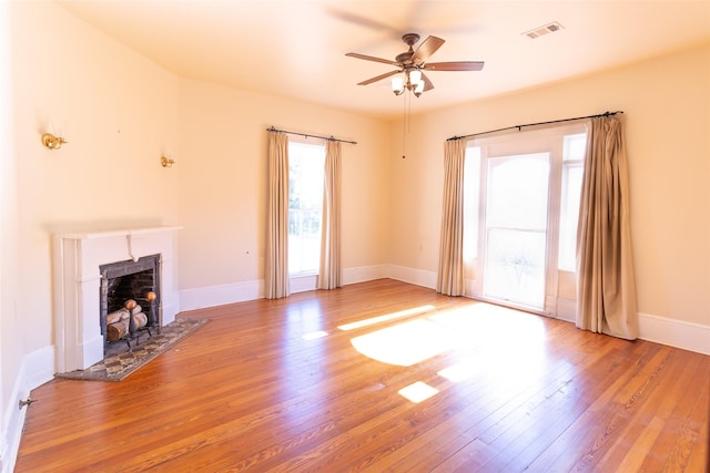 unfurnished living room with ceiling fan and light hardwood / wood-style floors