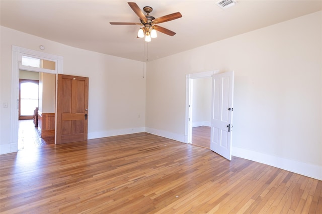 empty room featuring ceiling fan and light wood-type flooring