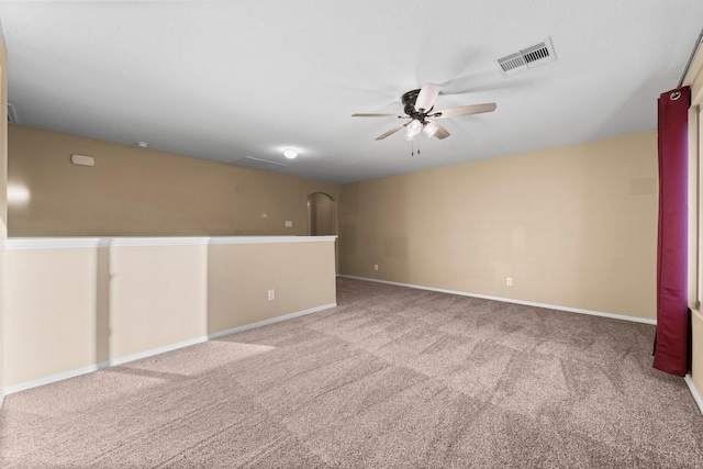 empty room featuring carpet floors and ceiling fan