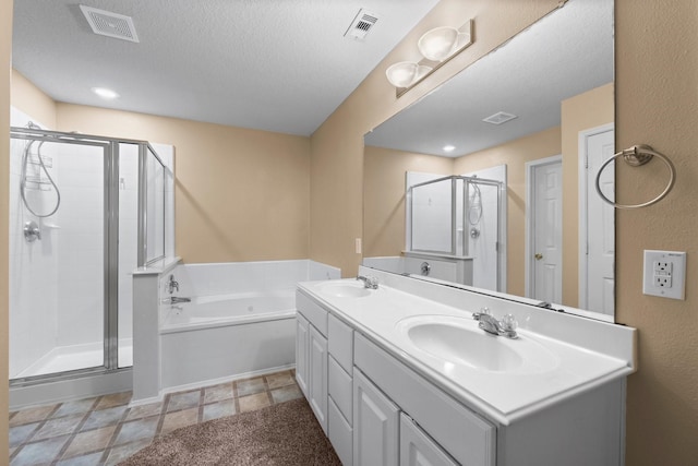 bathroom with vanity, plus walk in shower, and a textured ceiling