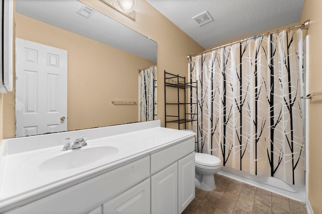 full bathroom featuring vanity, toilet, shower / bath combo with shower curtain, and a textured ceiling