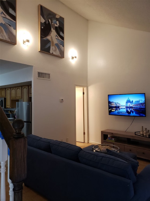 living room featuring a towering ceiling