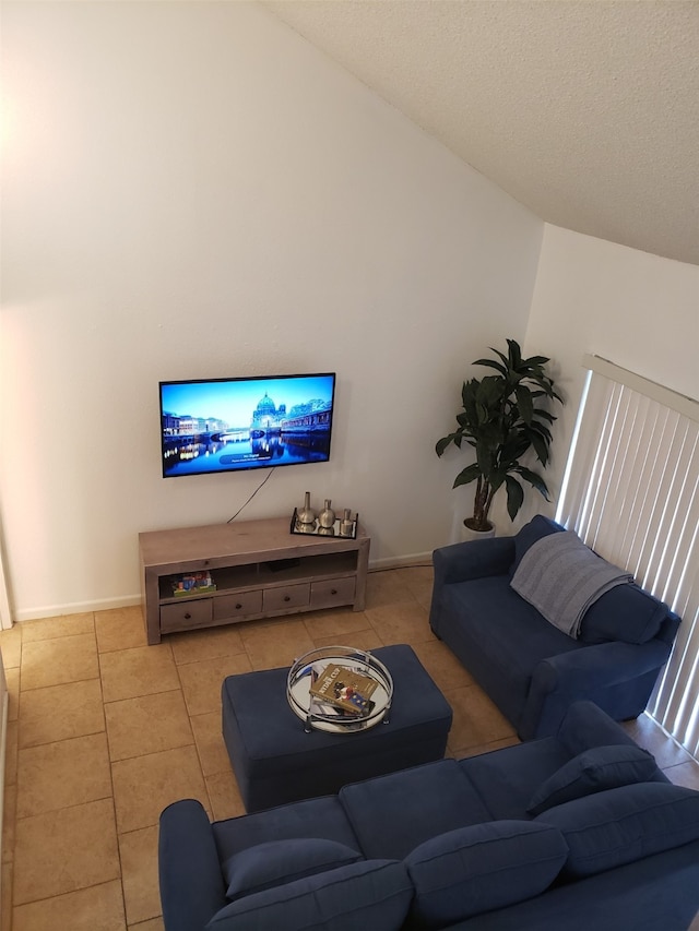 tiled living room with vaulted ceiling and a textured ceiling