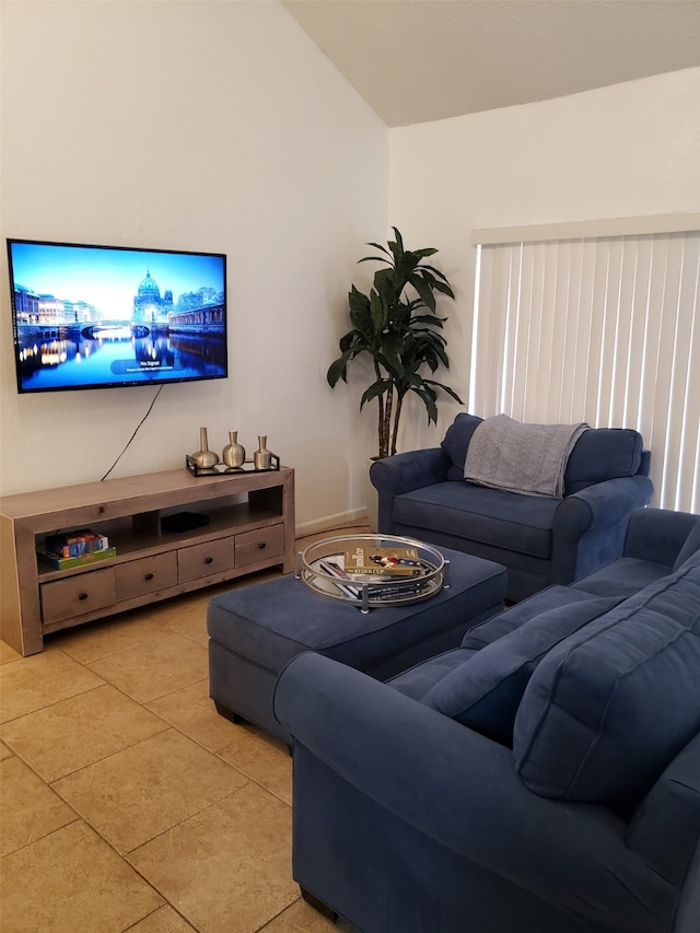 tiled living room featuring vaulted ceiling