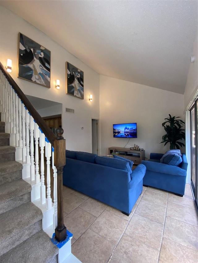 living room featuring light tile patterned flooring and lofted ceiling