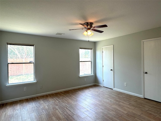 unfurnished room with light hardwood / wood-style flooring and ceiling fan