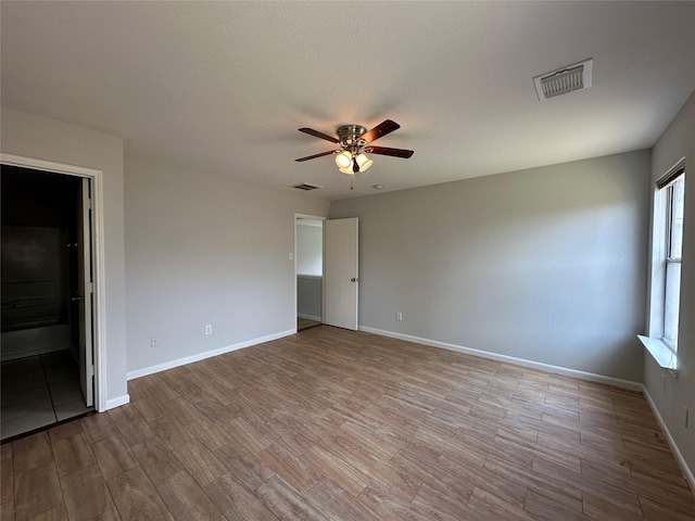 spare room featuring ceiling fan and light wood-type flooring