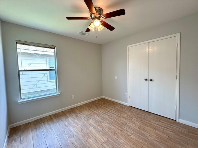 unfurnished bedroom featuring a closet, ceiling fan, and light wood-type flooring