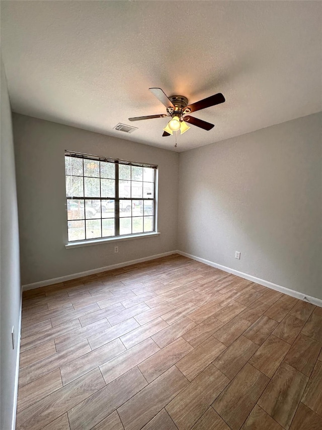 spare room with ceiling fan and a textured ceiling