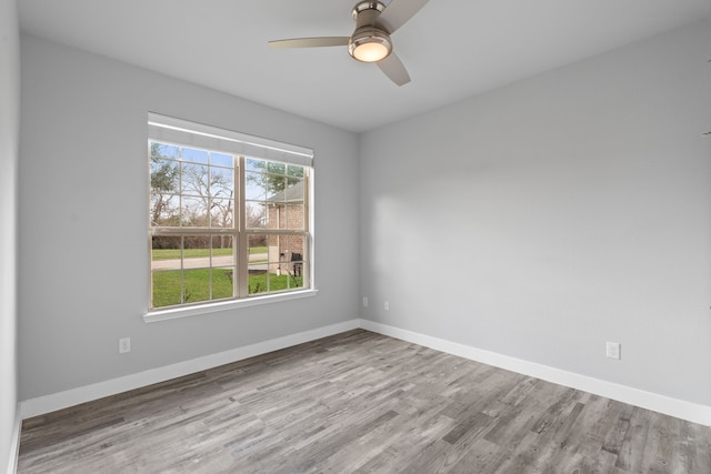 spare room featuring light hardwood / wood-style floors and ceiling fan