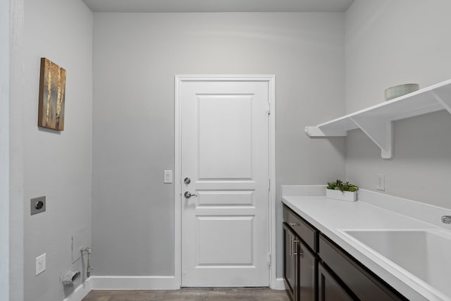 washroom with cabinets, hardwood / wood-style floors, sink, and hookup for an electric dryer