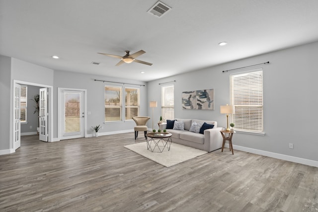 living room with hardwood / wood-style flooring and ceiling fan