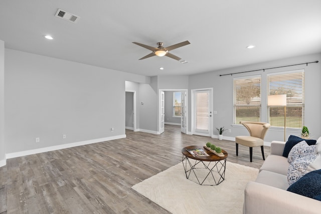 living room featuring ceiling fan and light wood-type flooring