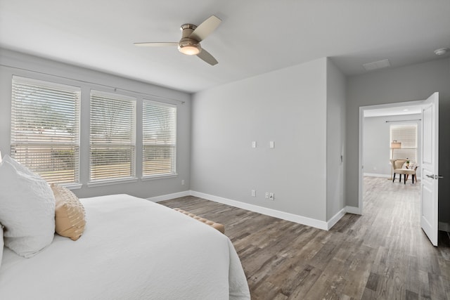 bedroom with ceiling fan and wood-type flooring