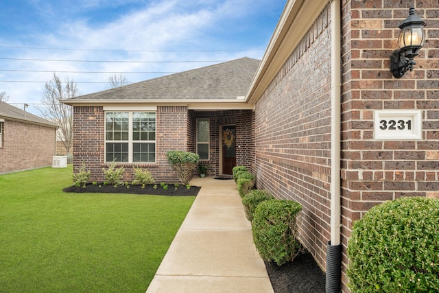 doorway to property featuring a lawn