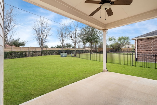 view of yard with ceiling fan and a patio area