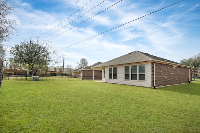 rear view of house featuring a lawn