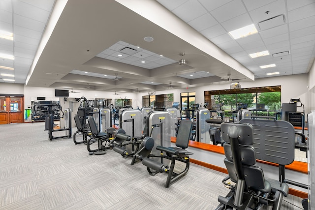 gym featuring ceiling fan, light colored carpet, and a drop ceiling