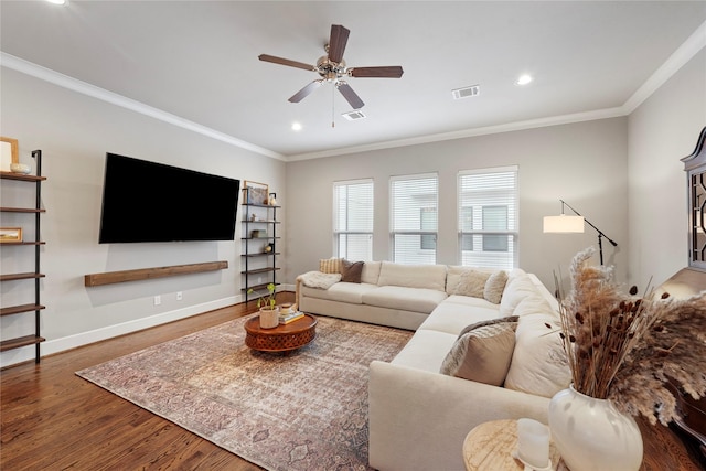 living room featuring ceiling fan, ornamental molding, and wood-type flooring