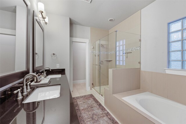 bathroom featuring tile patterned floors, a healthy amount of sunlight, independent shower and bath, and vanity