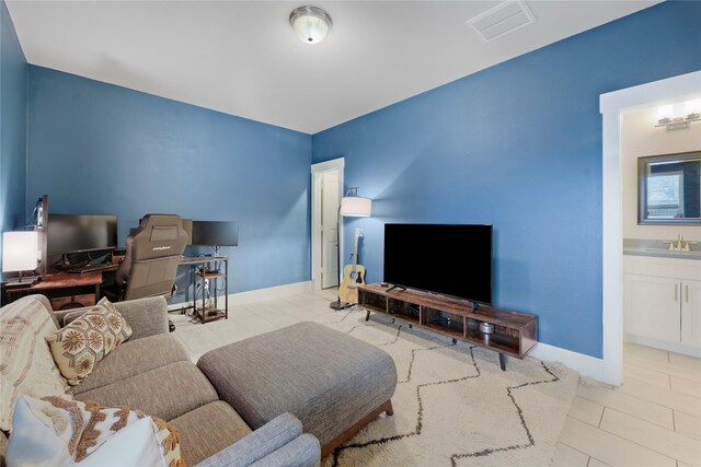 living room with sink and light tile patterned floors