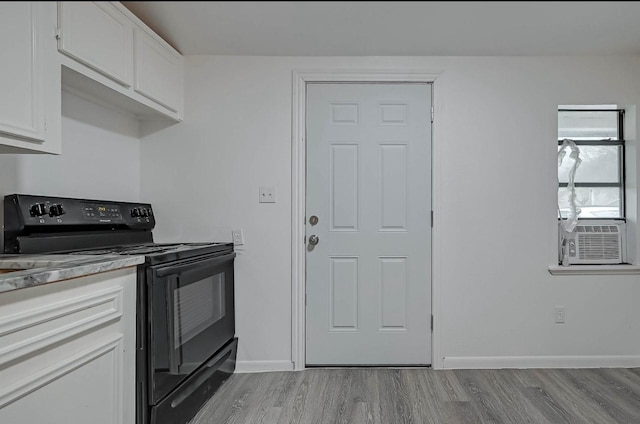 kitchen featuring white cabinetry, black electric range, cooling unit, and light wood-type flooring