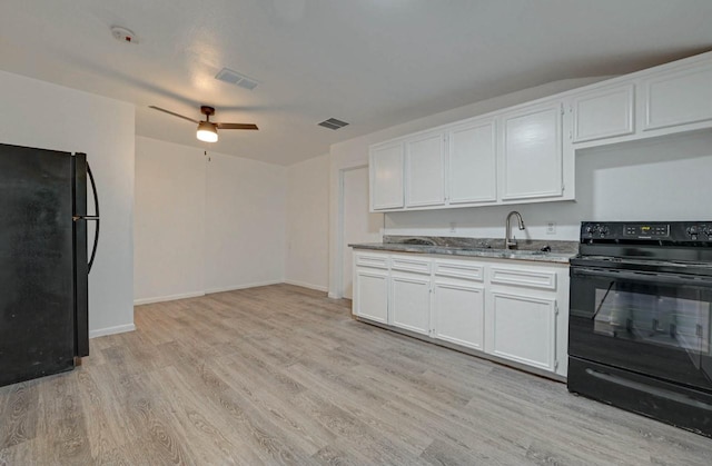 kitchen with sink, light hardwood / wood-style flooring, ceiling fan, black appliances, and white cabinets