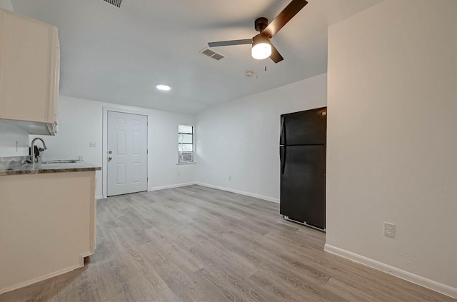 interior space featuring sink, ceiling fan, and light hardwood / wood-style flooring