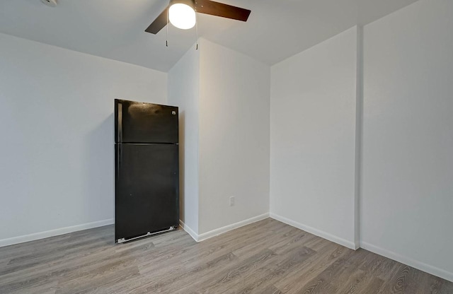 empty room with ceiling fan and light wood-type flooring