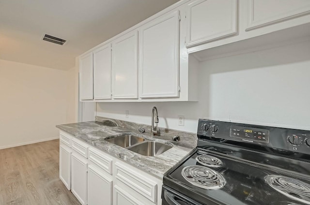 kitchen with sink, light hardwood / wood-style flooring, electric range, light stone countertops, and white cabinets