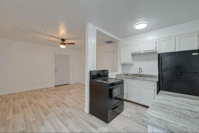 kitchen featuring black appliances, sink, white cabinets, ceiling fan, and light hardwood / wood-style floors