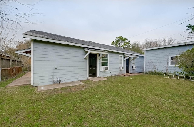 back of house featuring a yard