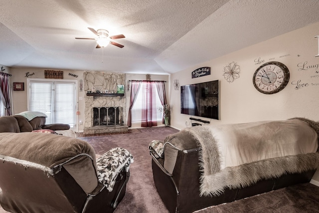 living room with ceiling fan, a fireplace, carpet floors, a textured ceiling, and vaulted ceiling