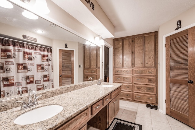 bathroom featuring tile patterned flooring and vanity