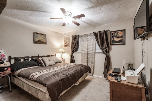 carpeted bedroom with ceiling fan and a textured ceiling