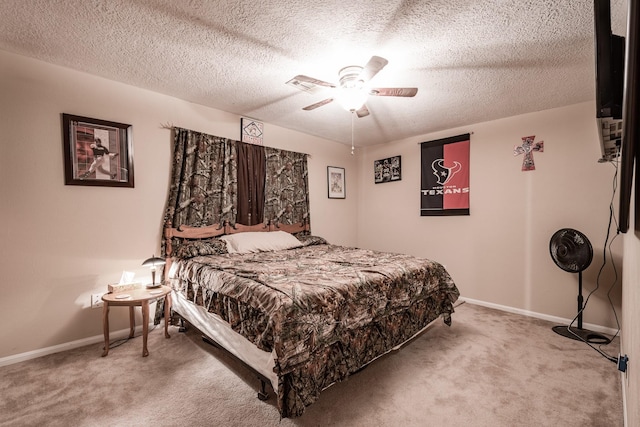 carpeted bedroom featuring ceiling fan and a textured ceiling