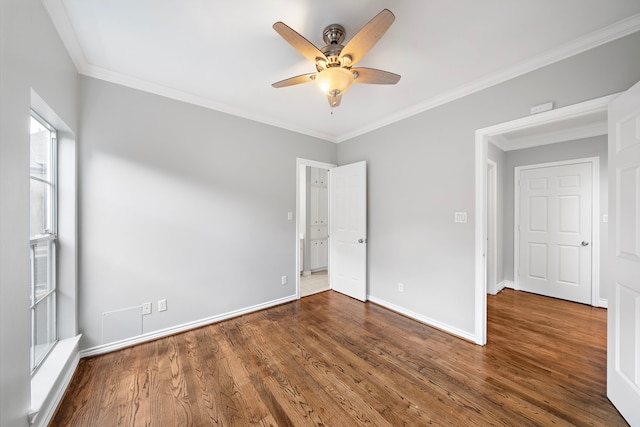 unfurnished bedroom with crown molding, dark hardwood / wood-style floors, and ceiling fan