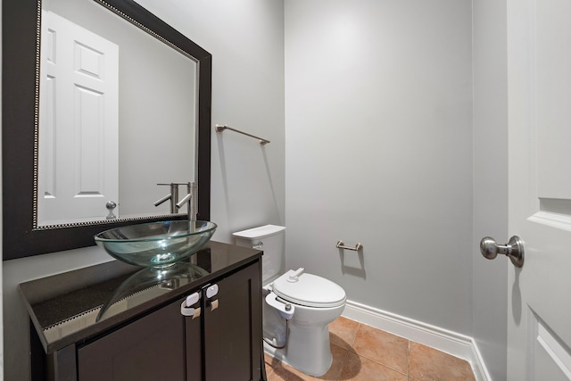 bathroom with vanity, toilet, and tile patterned flooring