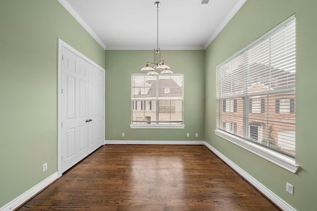 unfurnished dining area featuring dark hardwood / wood-style flooring, a notable chandelier, and ornamental molding