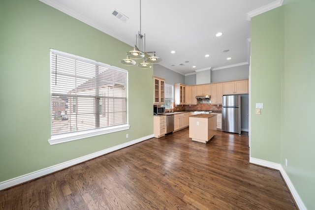 kitchen with a kitchen island, decorative light fixtures, tasteful backsplash, stainless steel appliances, and crown molding