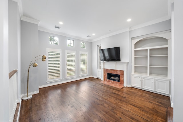 unfurnished living room featuring ornamental molding, dark hardwood / wood-style floors, built in features, and a fireplace